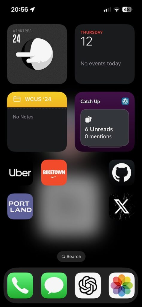 A screenshot of an iPhone home screen showing app icons and widgets.